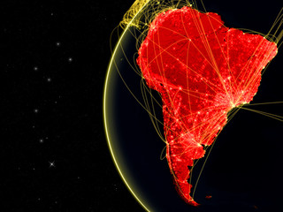 South America on dark Earth with network representing telecommunications, internet or intercontinental air traffic.