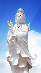 guan yin the goddess of mercy statue with sky background