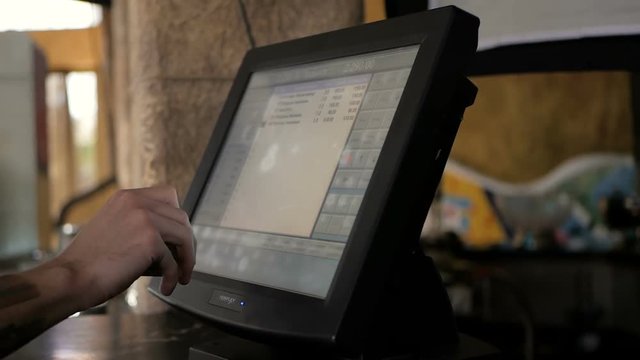 Man or waiter at counter with cashbox working at the restaurant