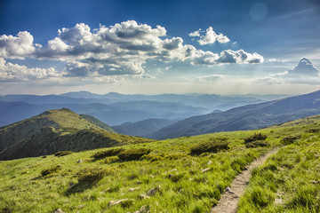 Scenic mountain view with green lawn