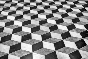 Cubic marble floor patterns in black and white.