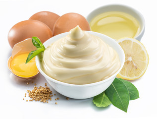 Mayonnaise sauce in white bowl with mayonnaise ingredients.