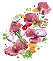 Falling down meat steaks and spices. Flying motion effect of cooking process.