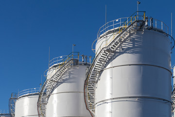 Fuel tanks at the tank farm. Big Industrial oil tanks in petroleum storage terminal