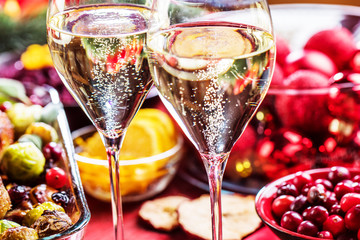 Christmas themed dinner table with champagne glass