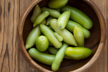 Green tomatoes on a wooden background. Tomato harvest