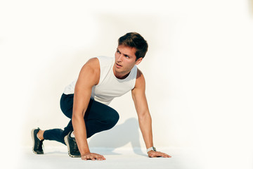 Obraz premium Young caucasian man working out isolated on white