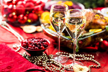 Obraz na płótnie Canvas Christmas themed dinner table with champagne glass