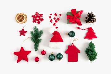 Christmas trendy composition. Xmas red and green decorations on white background. Christmas, New Year, winter concept. Flat lay, top view, copy space 