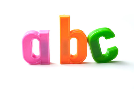 closeup of colorful plastic letters on white background - abc