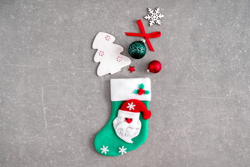 Christmas creative composition. Xmas sock with decorations on grey texture background. Christmas, New Year, winter concept. Flat lay, top view, copy space 