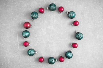 Christmas creative composition. Xmas red and green decorations on grey texture background. Christmas, New Year, winter concept. Flat lay, top view, copy space 