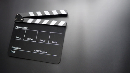Fototapeta na wymiar Clapper board or clap board or movie slate use in video production ,film,cinema industry. It's black color on black background.