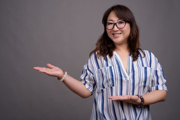 Portrait of mature Asian businesswoman wearing eyeglasses