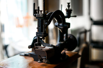 Ancient sewing machine Placed in an old-fashioned house in Thailand.soft focus.