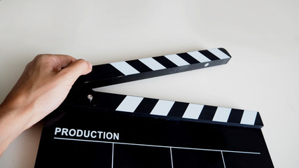 Hand with clapper board or movie slate use in video production or film and cinema industry. It's...