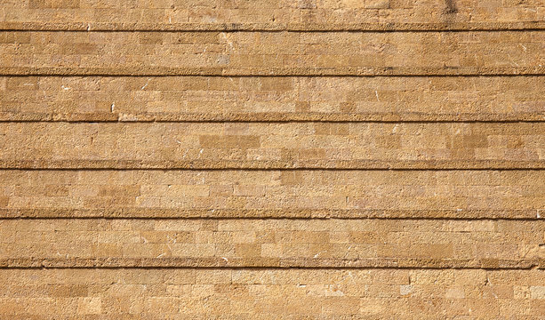 Sandstone brick wall with lines texture background