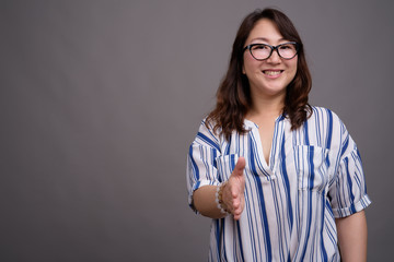 Portrait of mature Asian businesswoman wearing eyeglasses