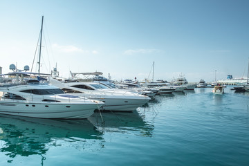 small boats and yachts are in the berth of the seaport of Sochi on the Black sea bright sunny summer day