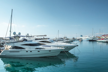 small boats and yachts are in the berth of the seaport of Sochi on the Black sea bright sunny...