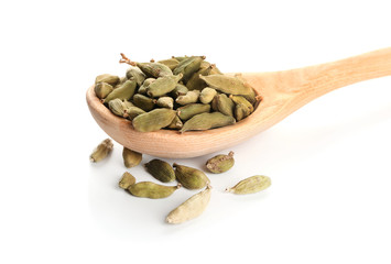 Wooden spoon with cardamom on white background