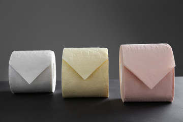 Rolls of toilet paper on grey table