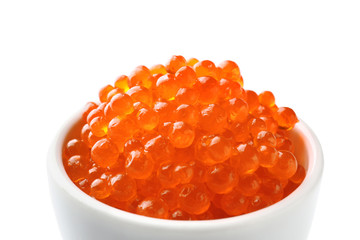 Bowl with delicious red caviar on white background, closeup