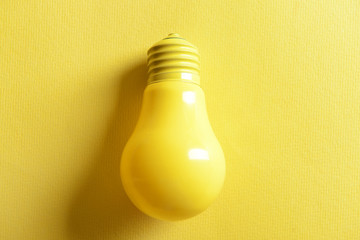 Painted light bulb on color background