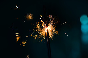 Fototapeta premium Festive Christmas sparklers on dark color background