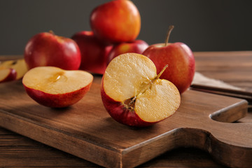 Cut tasty apple on wooden board