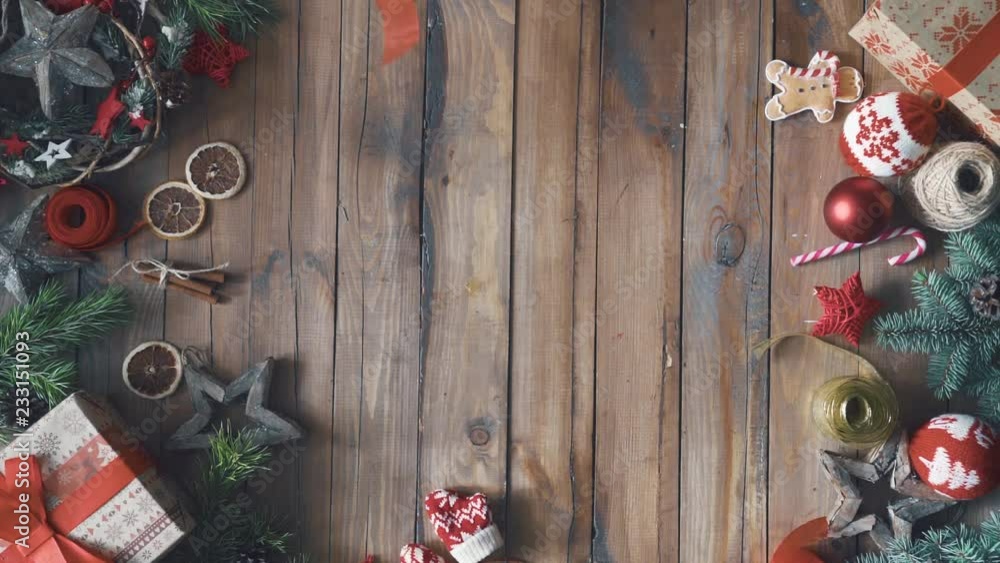 Wall mural Merry Christmas and Happy Holidays! A mother, father and their daughters preparing gifts. Baubles, presents, candy with ornaments. Top view. Xmas family traditions.