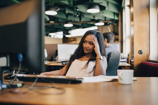 Concentrated businesswoman looking at computer monitor in office