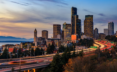 Seattle downtown skyline sunset from Dr. Jose Rizal or 12th Avenue South Bridge with traffic trail...