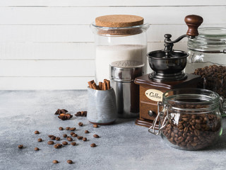 Various ingredients for making coffee, Glass jars with coffee beans, sugar, coffee grinder and...
