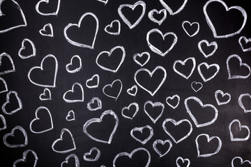 Fototapeta na wymiar hearts background on blackboard