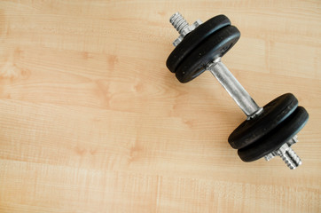 Dumbbell on the floor. Top view, close up. Sport theme. Fitness