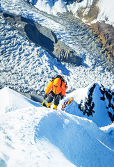 Climber reaches the top of mountain peak. Climbing and mountaineering sport. Nepal mountains.
