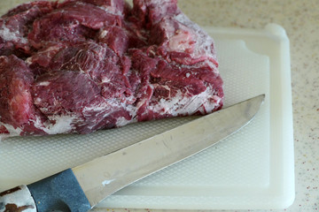 frozen beef in refrigerator, left to thaw,