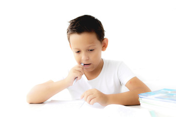 boy schoolboy teaches lessons writing in notebook and reading books nibbling pen on white isolated background