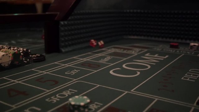 Dice being tossed on a craps table