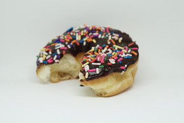bitten chocolate doughnut on an isolated white background