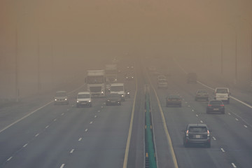 Dense fog and poor visibility on the road. Dangerous driving situations. View on highway traffic in...