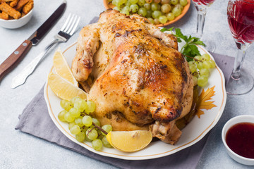 Baked chicken, mashed potatoes and wine glasses for dinner on the festive table.