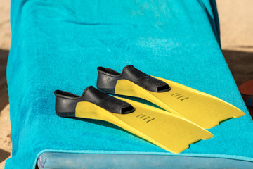 Black and Yellow Diving Fins on a Blue Towel