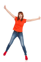 Casual Young Woman Is Standing On One Leg, Holding Arms Outstretched And Shouting