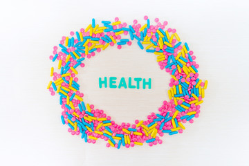 The word letters Health and various medication and pills