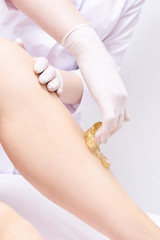 Depilation spa procedure. Woman hair remove waxing. Epilation sugaring. Legs foot