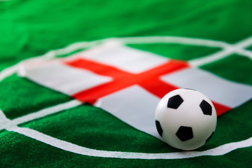 United Kingdom flag and soccer ball on green grass field