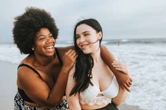 Smiling women standing on beach