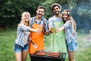 Friends spending time in nature and having barbecue